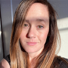 Woman with long hair and a neutral expression