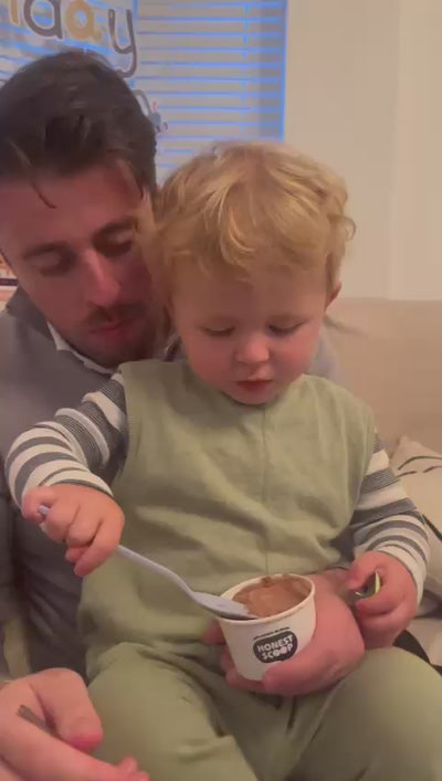Co-founder, James, with his son, Archie, who is scooping and enjoying some Honest Scoop ice cream.